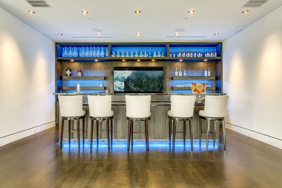 This is an example of a modern seated home bar in Dallas with glass benchtops, medium wood cabinets and open cabinets.