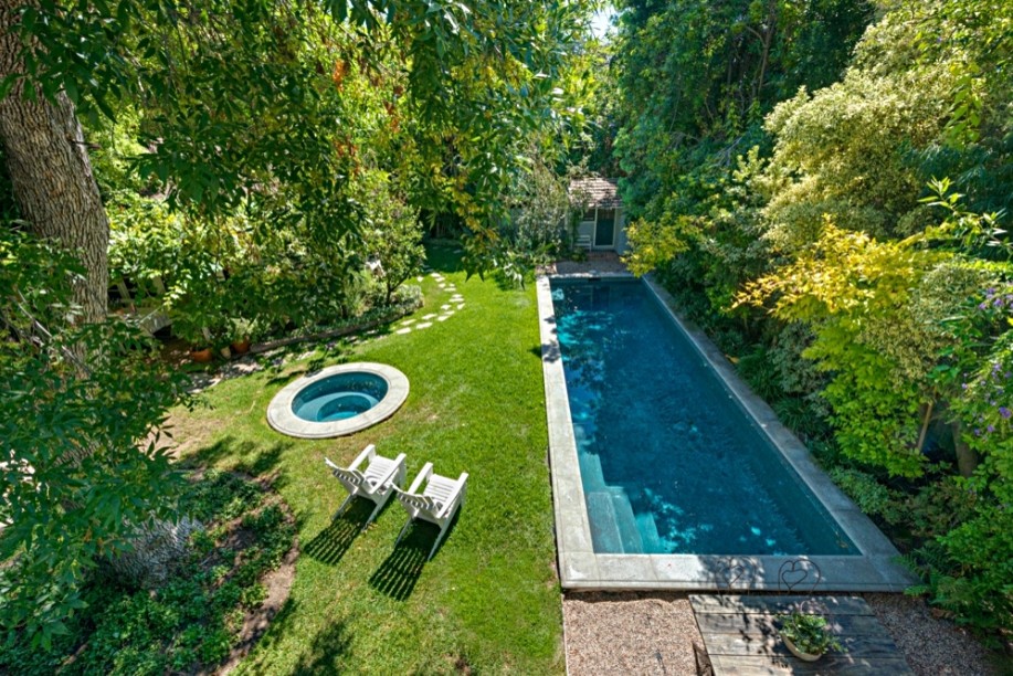 Large traditional backyard rectangular pool in Los Angeles with a hot tub.