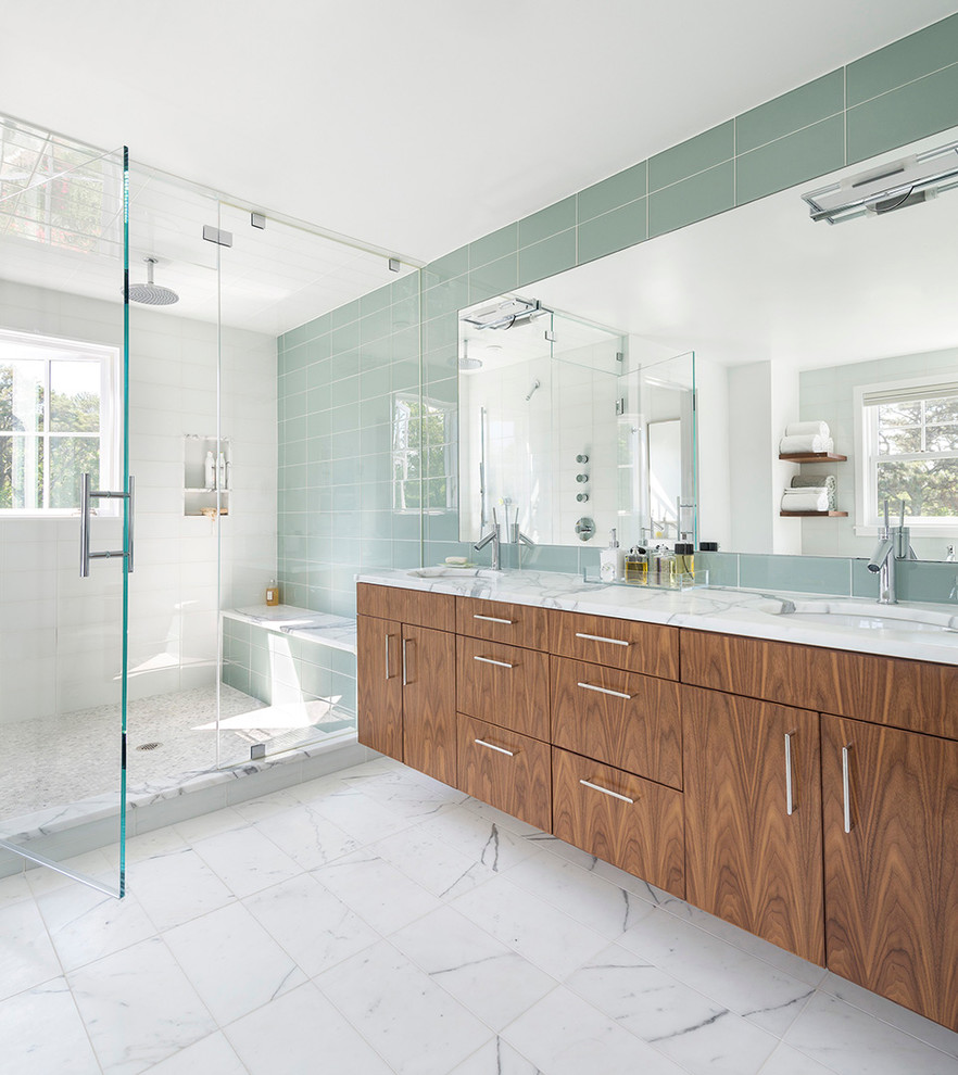 This is an example of a beach style bathroom in Boston with flat-panel cabinets, dark wood cabinets, an alcove shower, green tile and white walls.