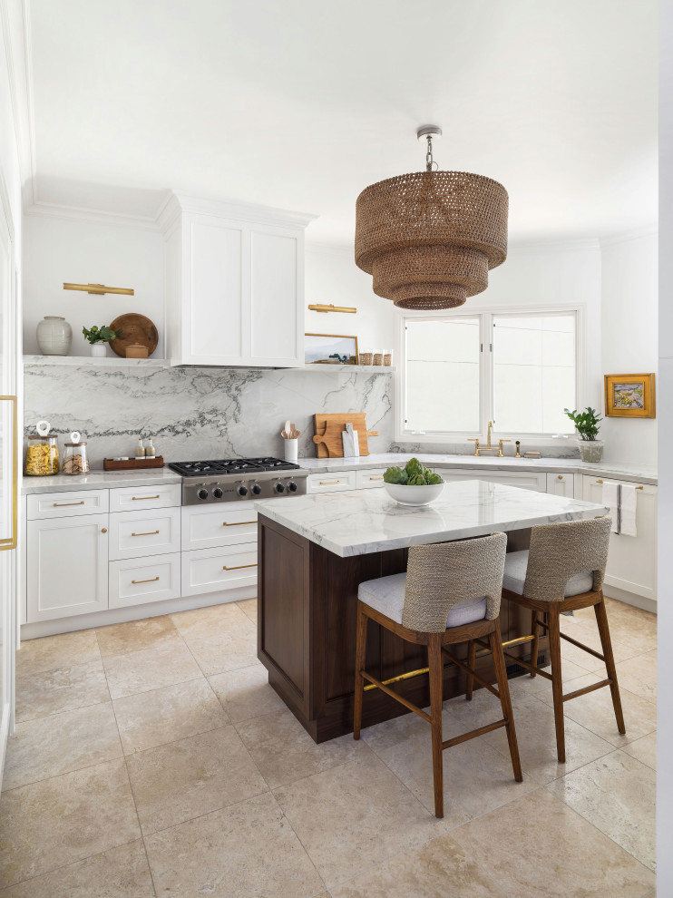 Photo of a large transitional u-shaped separate kitchen in San Diego with an undermount sink, beaded inset cabinets, white cabinets, quartzite benchtops, grey splashback, stone slab splashback, panelled appliances, limestone floors, with island, beige floor and grey benchtop.