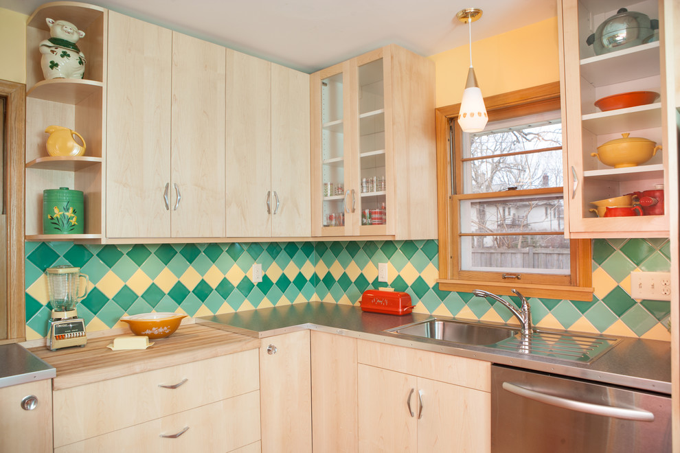 This is an example of a small midcentury u-shaped kitchen pantry in Minneapolis with flat-panel cabinets, light wood cabinets, laminate benchtops, green splashback, ceramic splashback, stainless steel appliances, linoleum floors, no island and a single-bowl sink.