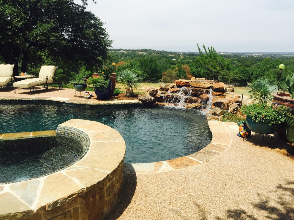 Large traditional backyard custom-shaped lap pool in Dallas with a hot tub and decomposed granite.