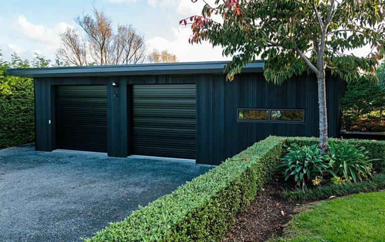 Photo of a contemporary garage in Auckland.