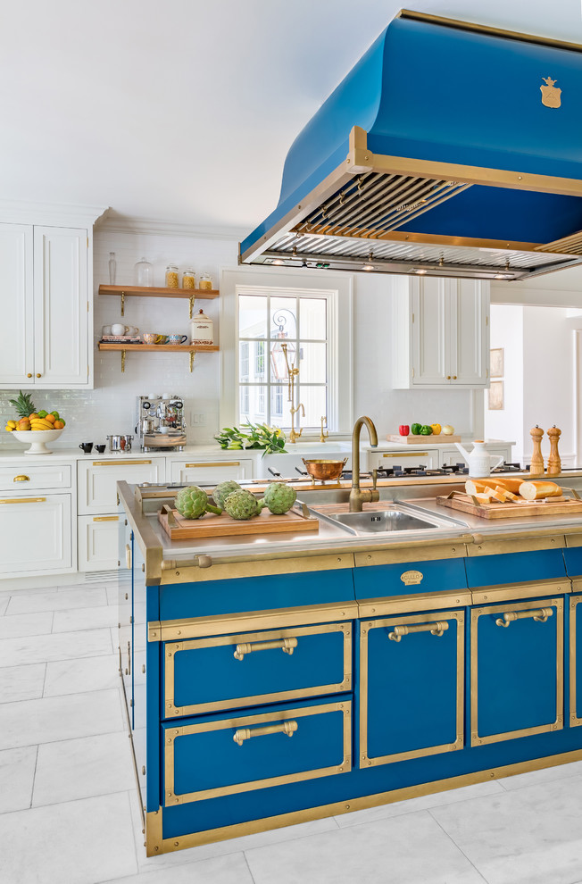This is an example of a traditional eat-in kitchen in New York with stainless steel cabinets, stainless steel benchtops, blue splashback and blue benchtop.