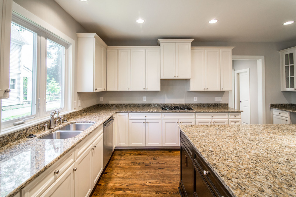 Inspiration for a large u-shaped dark wood floor eat-in kitchen remodel in DC Metro with an undermount sink, recessed-panel cabinets, granite countertops, stainless steel appliances and an island