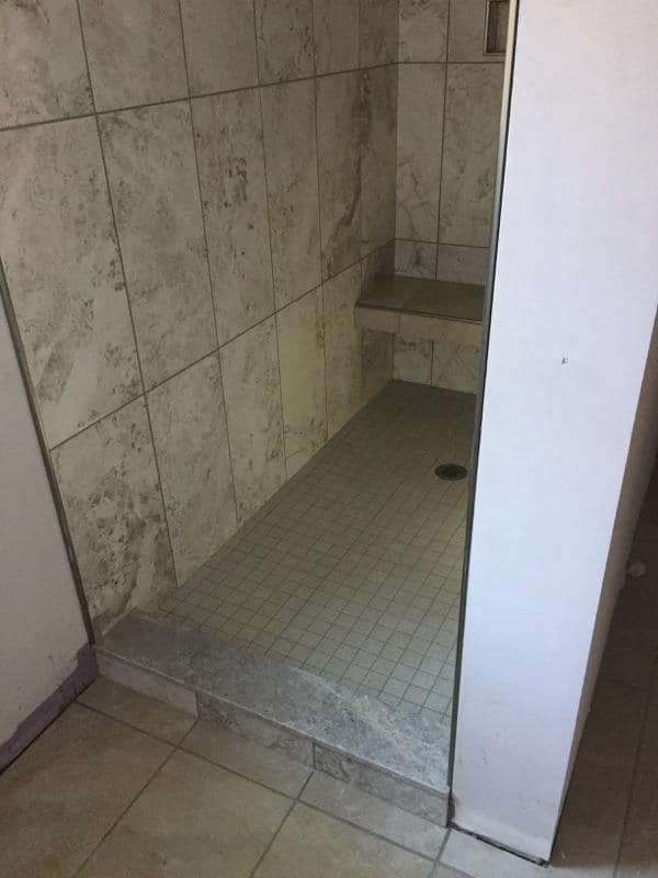 12*24 North Native Granite shower with Oasis Dark Grey master bath floor