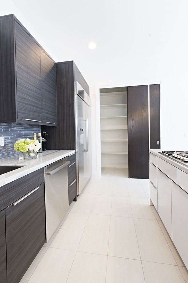 This is an example of a large contemporary single-wall kitchen in Houston with an undermount sink, flat-panel cabinets, black cabinets, quartzite benchtops, grey splashback, stone tile splashback, stainless steel appliances, porcelain floors, with island and white floor.