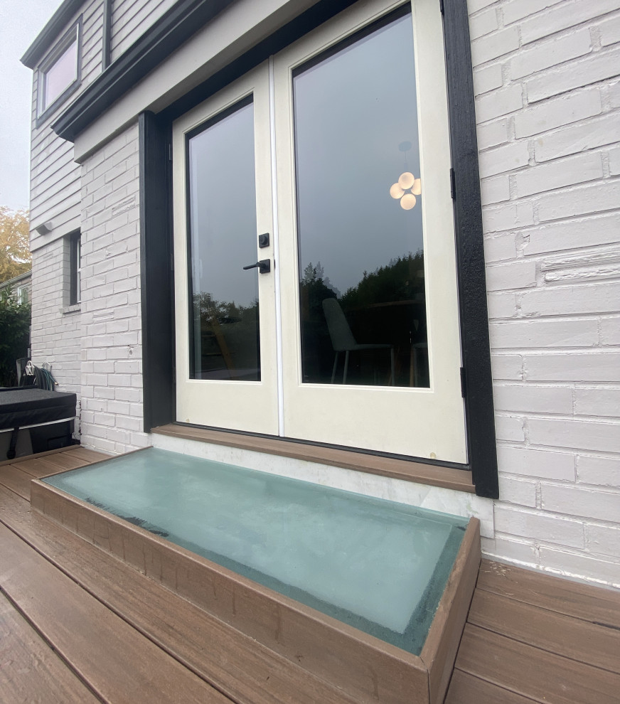 Inspiration for a mid-sized modern backyard pool remodel in Seattle with decking