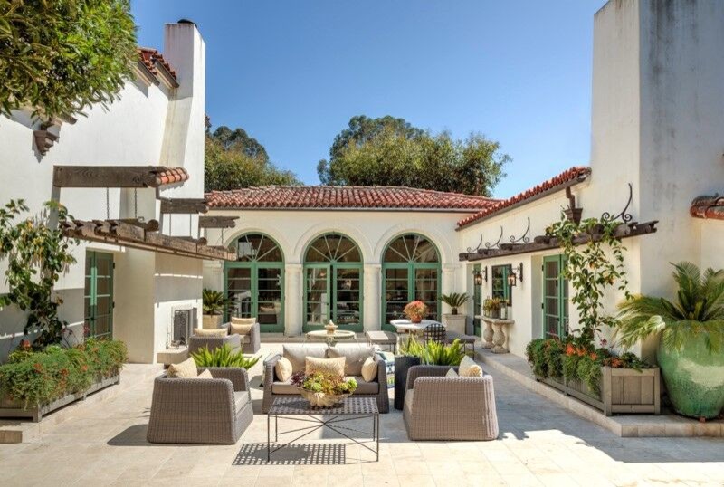 Photo of a large mediterranean backyard patio in Santa Barbara with a water feature and tile.