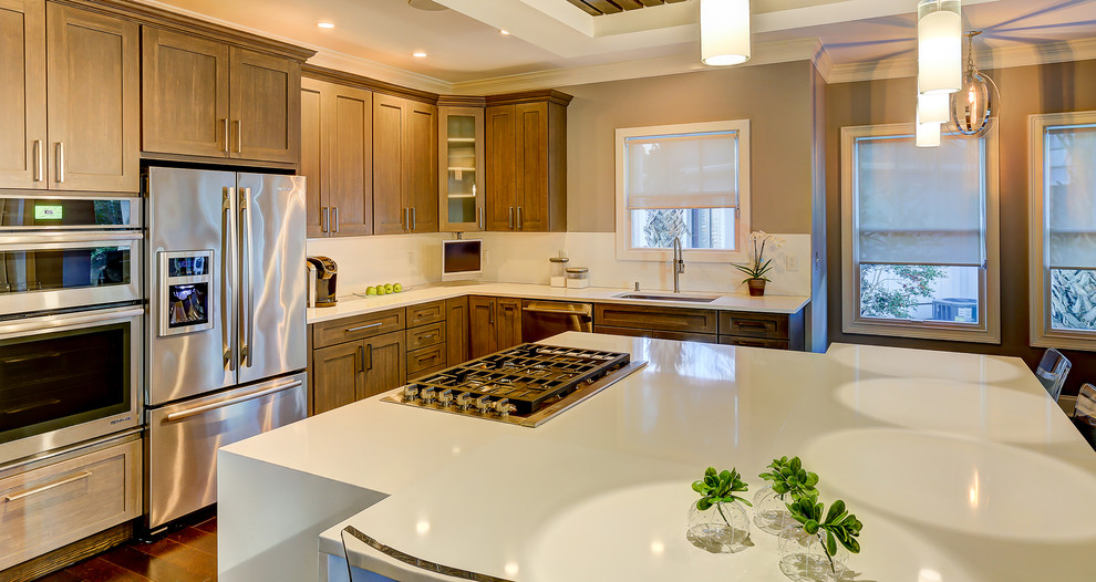 Kitchen - transitional dark wood floor kitchen idea with an undermount sink, gray cabinets, quartzite countertops, white backsplash, porcelain backsplash, stainless steel appliances and an island