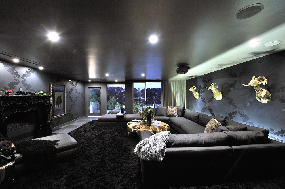 This is an example of a large contemporary enclosed home theatre in Los Angeles with black walls, ceramic floors, a built-in media wall and black floor.