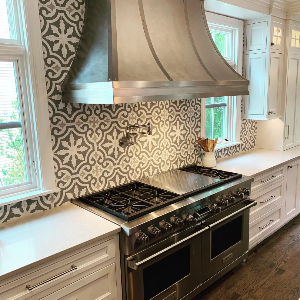 Inspiration for a large transitional l-shaped dark wood floor and brown floor open concept kitchen remodel in Chicago with recessed-panel cabinets, white cabinets, quartz countertops, cement tile backsplash, stainless steel appliances, an island and white countertops