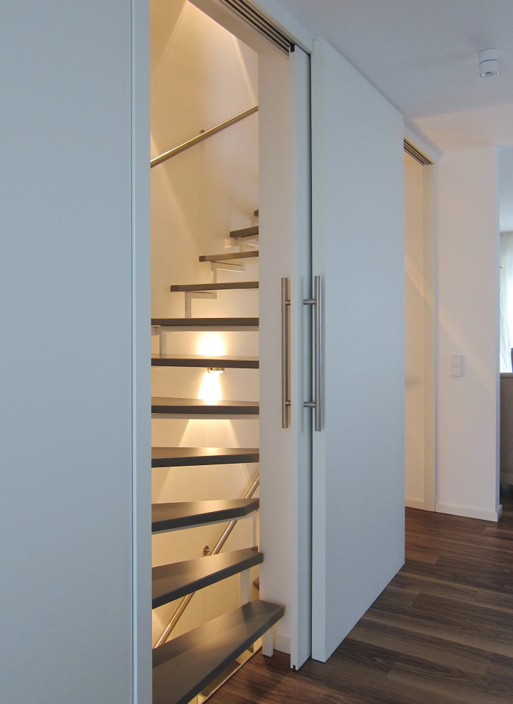 Staircase - mid-sized contemporary wooden u-shaped metal railing staircase idea in Cologne