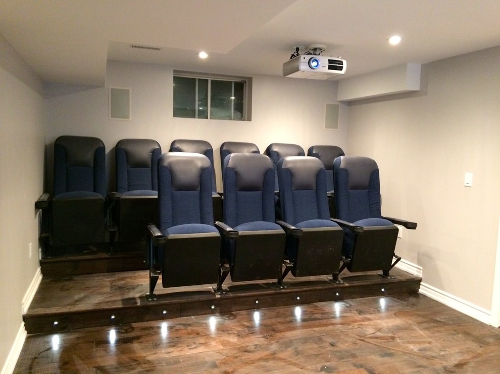 This is an example of a small modern enclosed home theatre in Toronto with purple walls, ceramic floors and a projector screen.