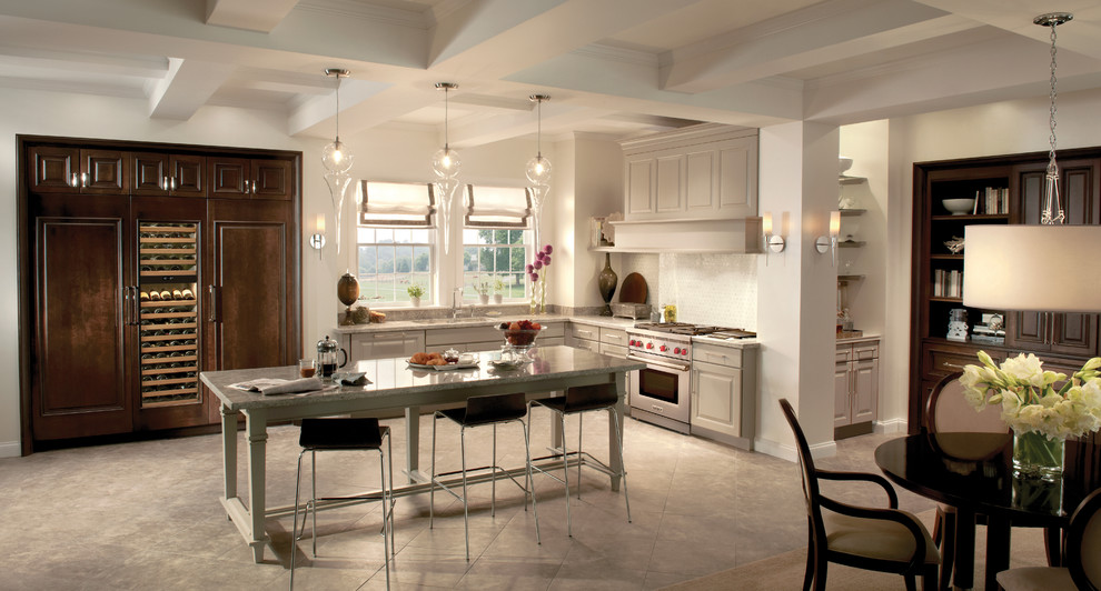 Inspiration for a huge transitional l-shaped slate floor home design remodel in New York with a double-bowl sink, beaded inset cabinets, dark wood cabinets, marble countertops, white backsplash, ceramic backsplash, paneled appliances and no island