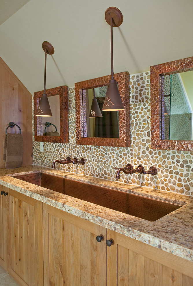 Inspiration for a large rustic master multicolored tile and stone tile ceramic tile bathroom remodel with light wood cabinets, granite countertops, beige walls, beaded inset cabinets and a trough sink