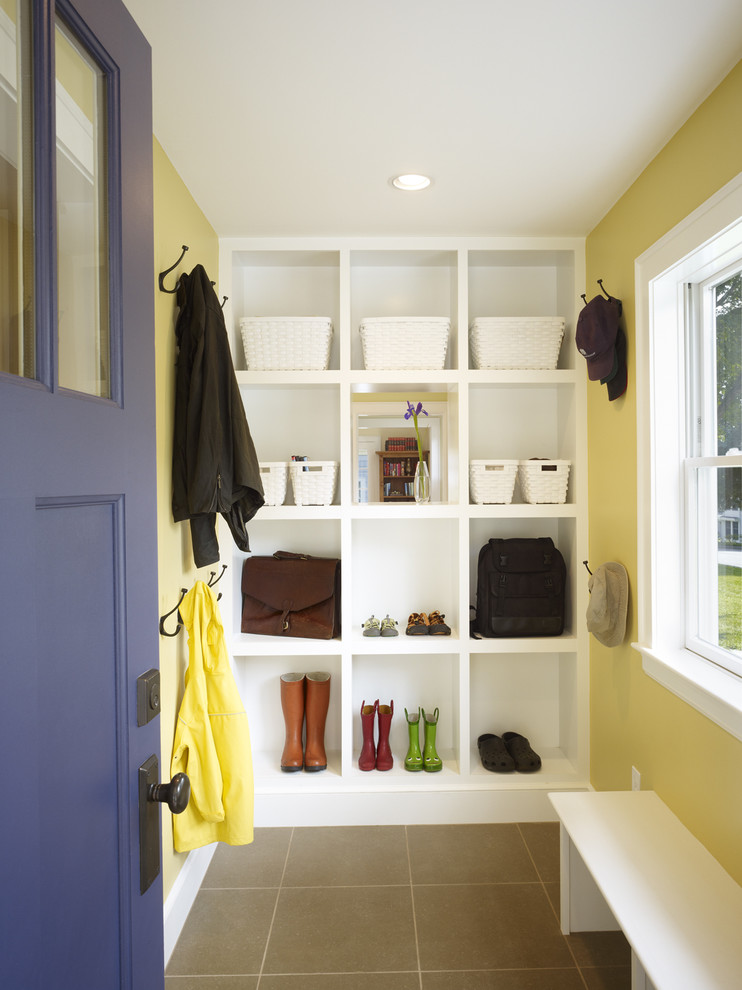 This is an example of a contemporary mudroom in Boston with yellow walls.