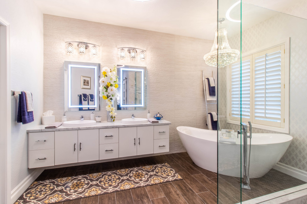 Design ideas for a large contemporary master bathroom in Phoenix with white cabinets, a freestanding tub, a corner shower, wood-look tile, quartzite benchtops, brown floor, an open shower, a floating vanity and wallpaper.