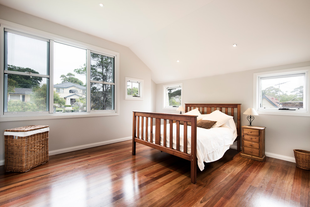 Design ideas for a large contemporary master bedroom in Sydney with white walls, light hardwood floors and no fireplace.