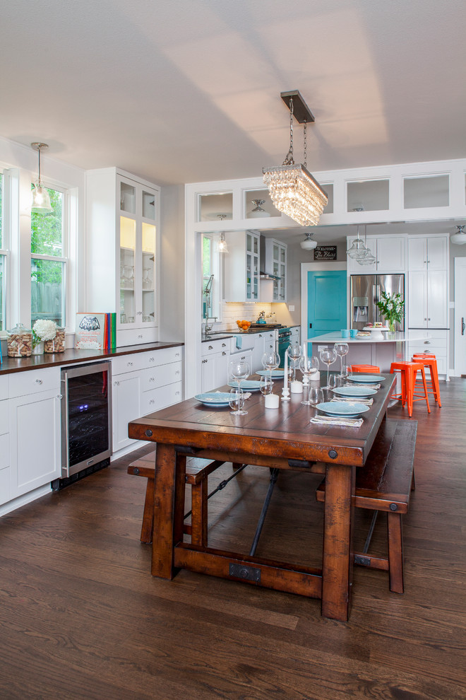 Inspiration for a mid-sized transitional kitchen/dining combo in Austin with grey walls and medium hardwood floors.