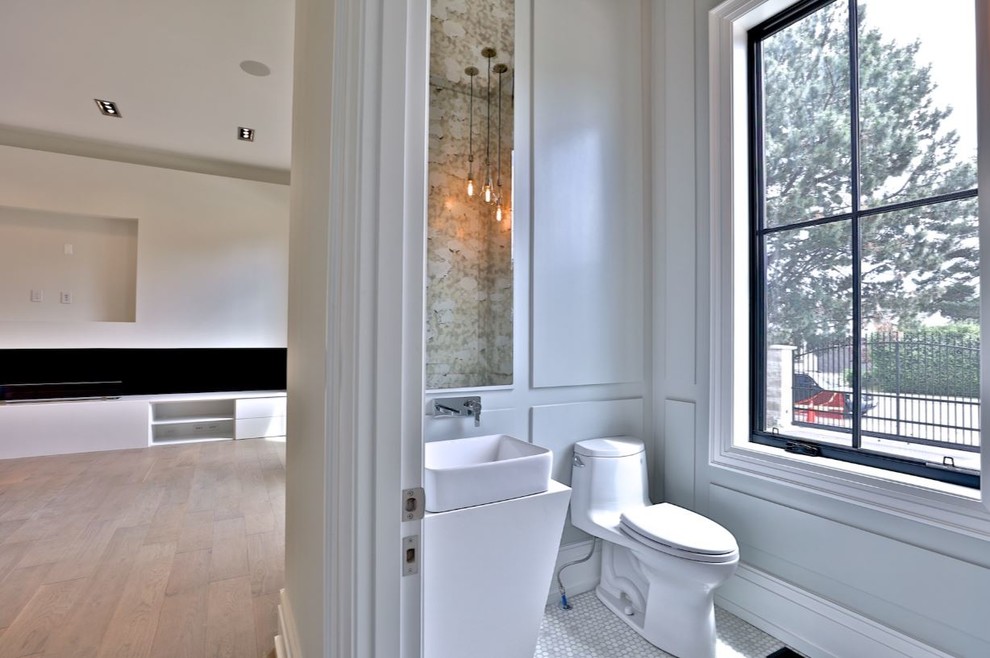 This is an example of a mid-sized modern bathroom in Toronto with flat-panel cabinets, light wood cabinets, a drop-in tub, a curbless shower, white tile, ceramic tile, beige walls, medium hardwood floors, engineered quartz benchtops, beige floor and white benchtops.