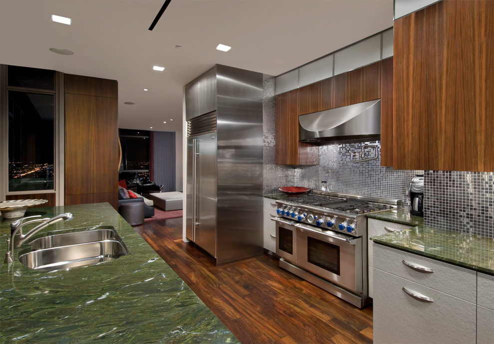 Design ideas for a mid-sized contemporary galley eat-in kitchen in Chicago with an undermount sink, flat-panel cabinets, medium wood cabinets, metallic splashback, stainless steel appliances, mosaic tile splashback, granite benchtops, dark hardwood floors, with island, brown floor and green benchtop.