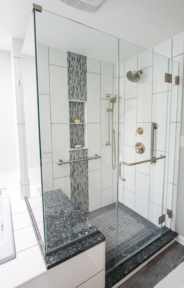 Corner shower - white tile and porcelain tile porcelain tile and gray floor corner shower idea in Baltimore with white walls and a hinged shower door