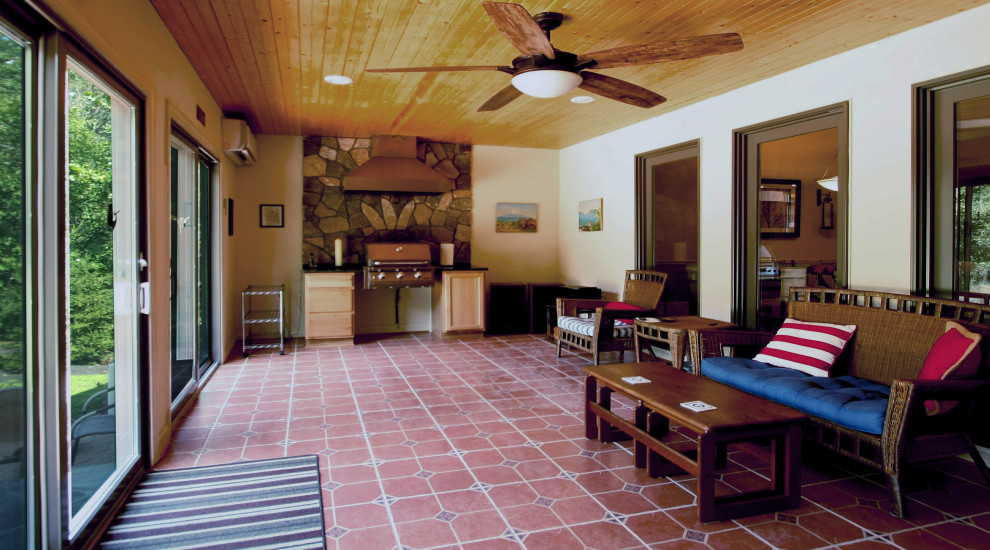 Large traditional sunroom in DC Metro with terra-cotta floors, no fireplace, a standard ceiling and orange floor.