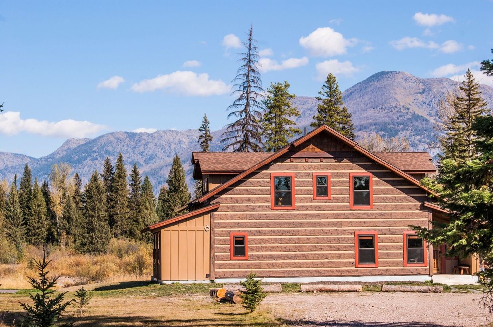 Mid-sized mountain style brown two-story wood gable roof photo with a shingle roof