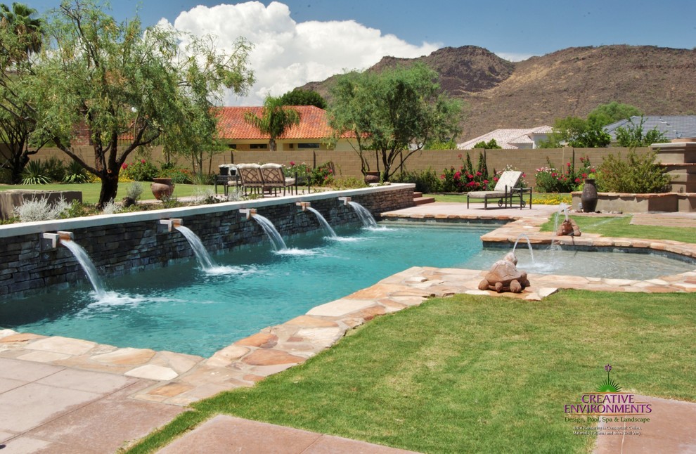Inspiration for a large backyard stamped concrete and custom-shaped hot tub remodel in Phoenix