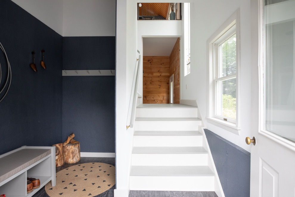 Design ideas for a small industrial mudroom in Portland Maine with grey walls, slate floors, a single front door, a white front door and grey floor.