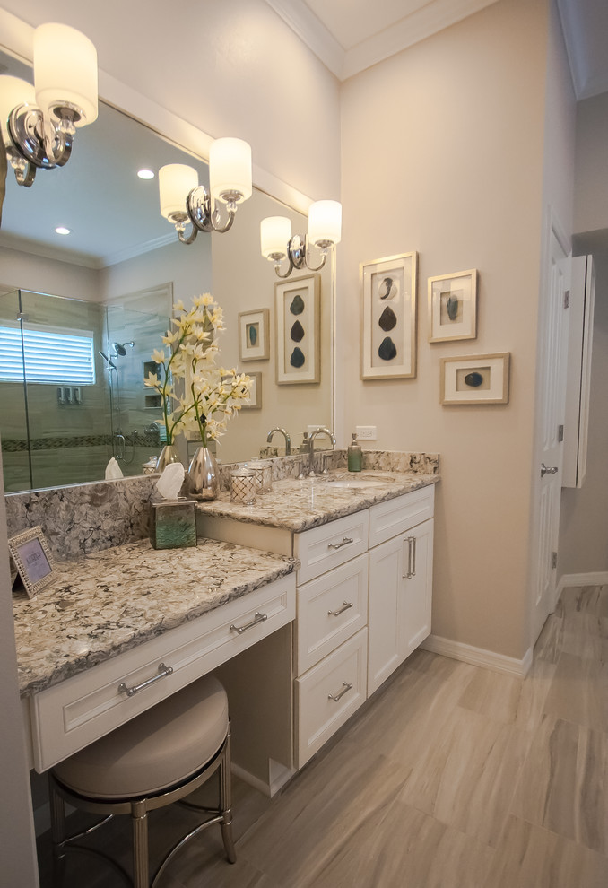 Photo of a large transitional master bathroom in Tampa with recessed-panel cabinets, white cabinets, a freestanding tub, a double shower, a one-piece toilet, gray tile, porcelain tile, grey walls, porcelain floors, an undermount sink, engineered quartz benchtops, multi-coloured floor and a hinged shower door.