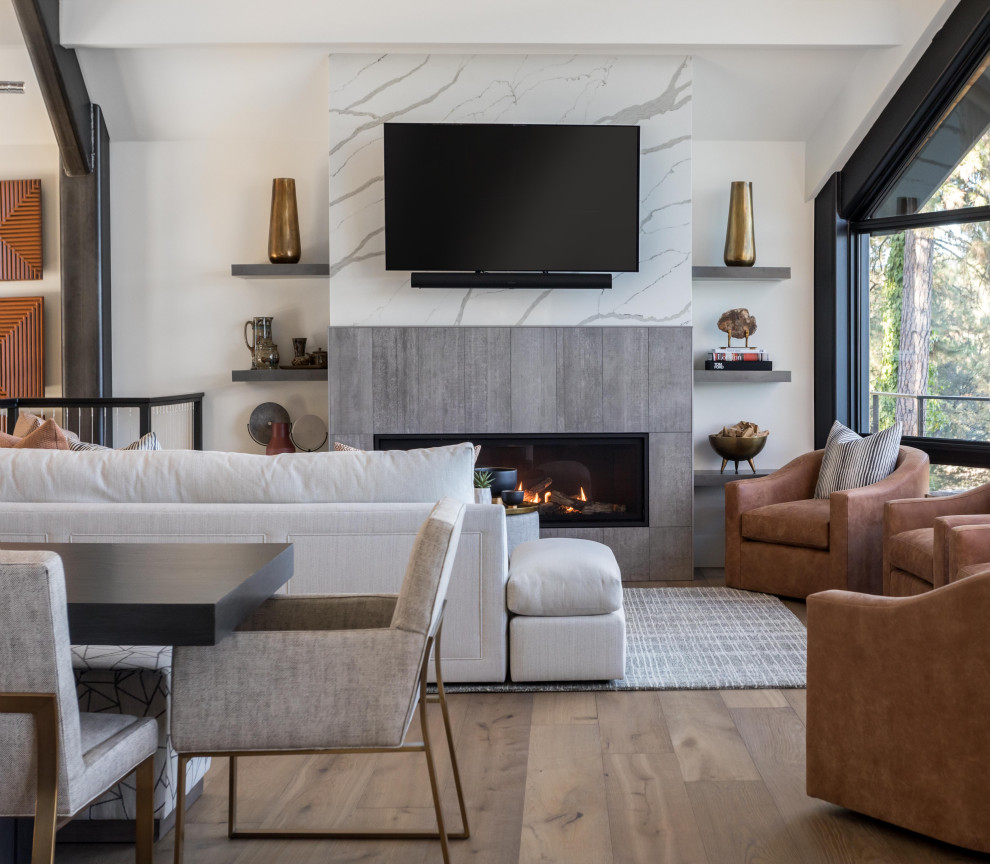 Medium sized contemporary formal open plan living room in Sacramento with white walls, medium hardwood flooring, a standard fireplace, a tiled fireplace surround, a wall mounted tv, brown floors and exposed beams.