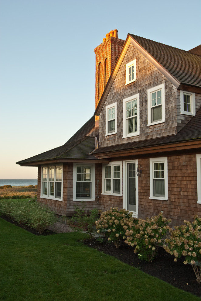 Inspiration for a traditional two-storey brown exterior in Providence with wood siding and a gable roof.