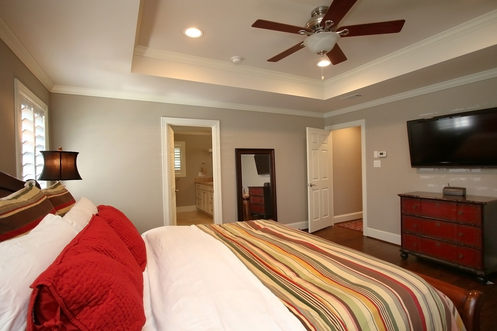 Design ideas for a modern master bedroom in Houston with beige walls and dark hardwood floors.