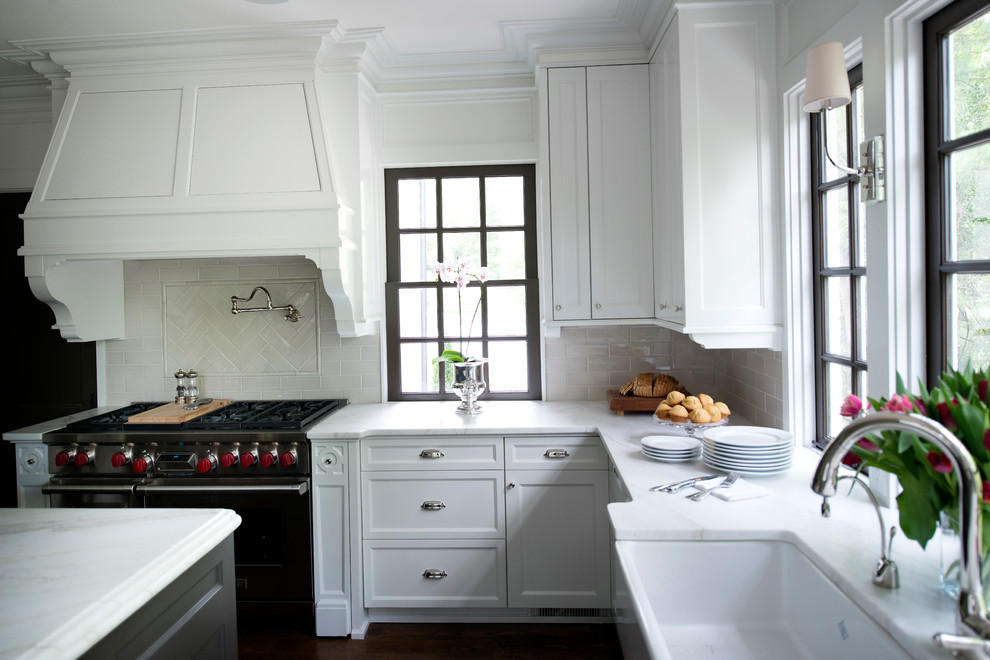 Example of a transitional medium tone wood floor kitchen design in Atlanta with beaded inset cabinets, white backsplash, stainless steel appliances and an island