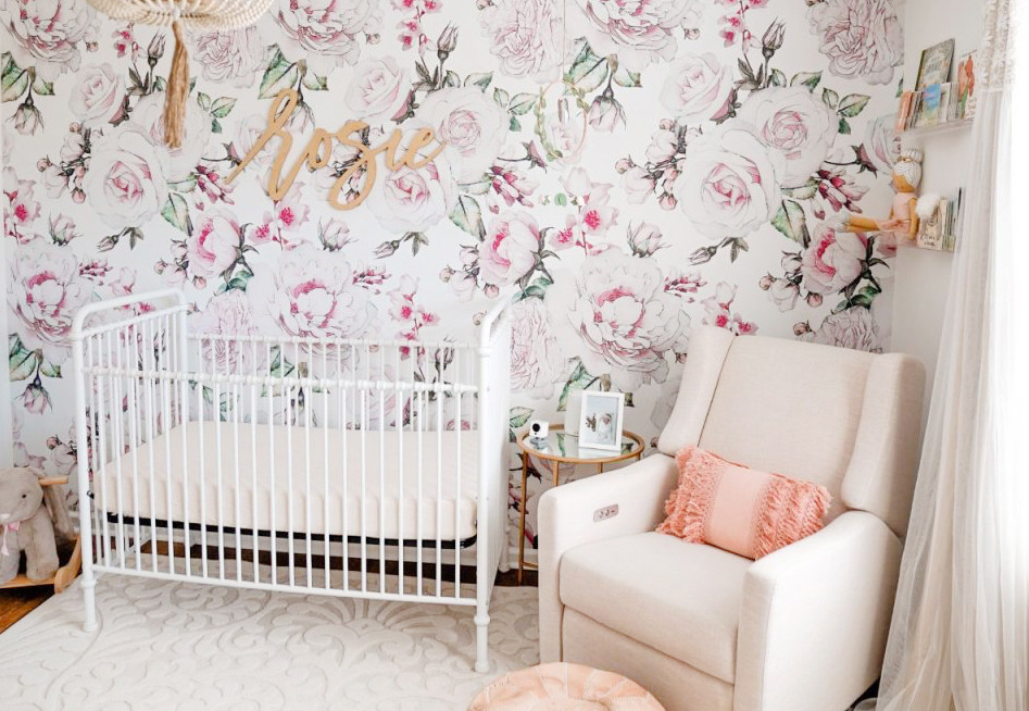 Photo of a mid-sized contemporary nursery for girls in Atlanta with white walls, medium hardwood floors, brown floor and wallpaper.