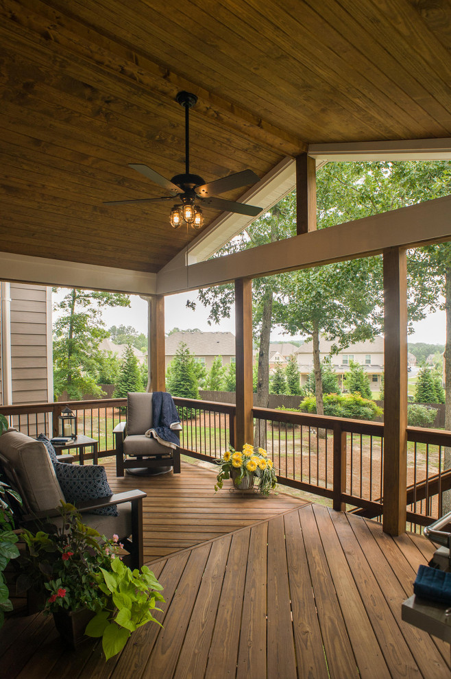This is an example of a mid-sized traditional mixed material railing back porch design in Atlanta with decking and a roof extension.