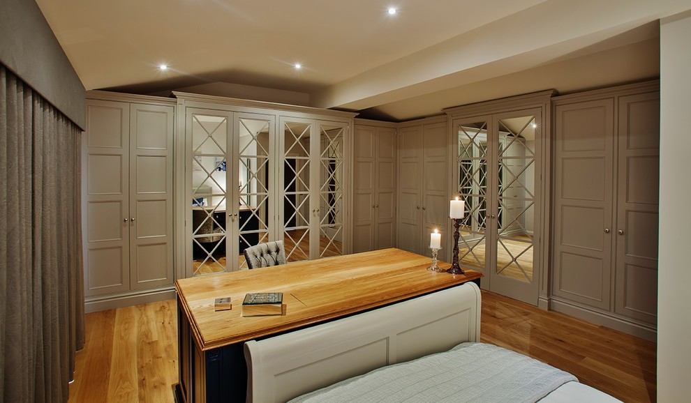 Inspiration for a traditional master bedroom in Edinburgh with grey walls and light hardwood floors.