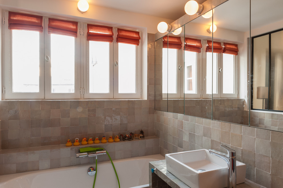 Mid-sized contemporary kids bathroom in Paris with beaded inset cabinets, orange cabinets, an undermount tub, a curbless shower, a wall-mount toilet, gray tile, ceramic tile, white walls, cement tiles, a drop-in sink and tile benchtops.