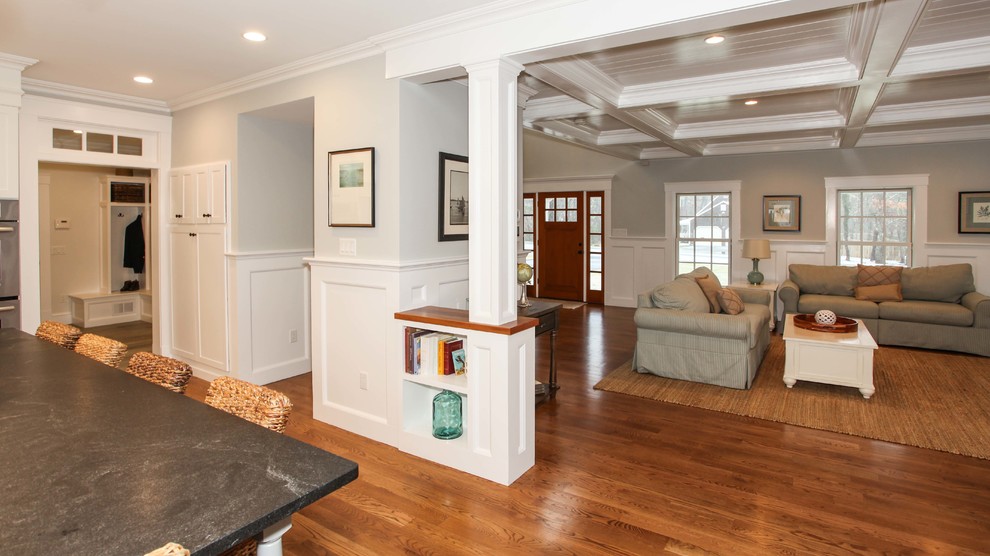Inspiration for a huge craftsman open concept medium tone wood floor home design remodel with gray walls and a media wall