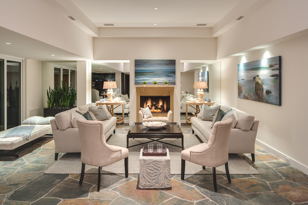 Expansive transitional living room in Orange County with white walls and a standard fireplace.