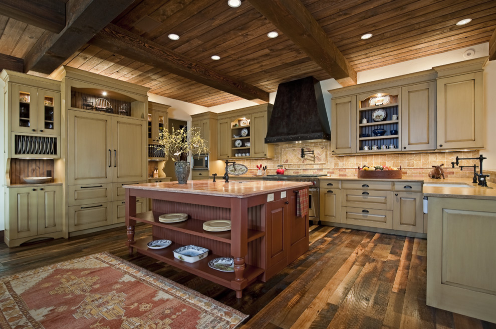 Photo of a country u-shaped kitchen in Austin with a farmhouse sink, raised-panel cabinets, beige cabinets, beige splashback and panelled appliances.