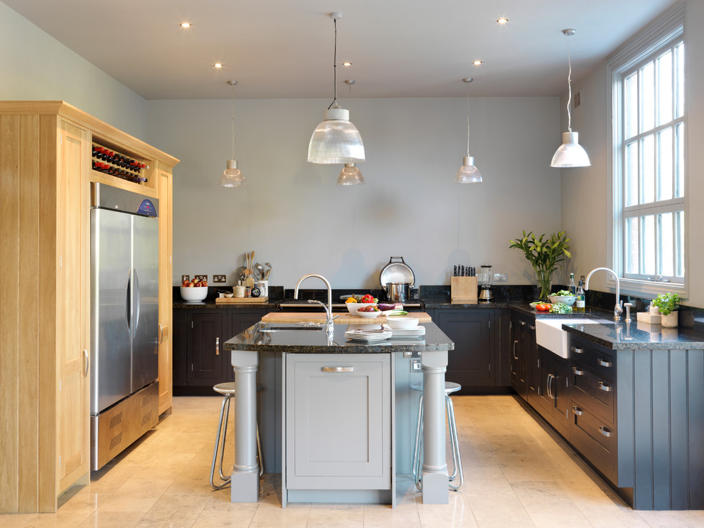 Inspiration for a large traditional u-shaped kitchen in London with a farmhouse sink, shaker cabinets, grey cabinets, stainless steel appliances and with island.