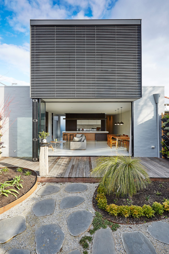 Inspiration for a mid-sized contemporary two-storey brick grey exterior in Melbourne with a flat roof.