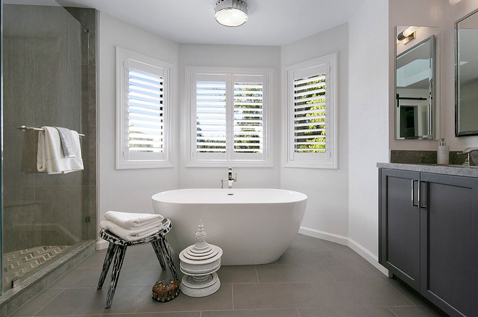 This is an example of a large classic grey and white ensuite bathroom in San Francisco with recessed-panel cabinets, grey cabinets, a freestanding bath, an alcove shower, a one-piece toilet, beige tiles, marble tiles, white walls, porcelain flooring, a submerged sink, engineered stone worktops, grey floors, a hinged door, multi-coloured worktops, double sinks and a built in vanity unit.