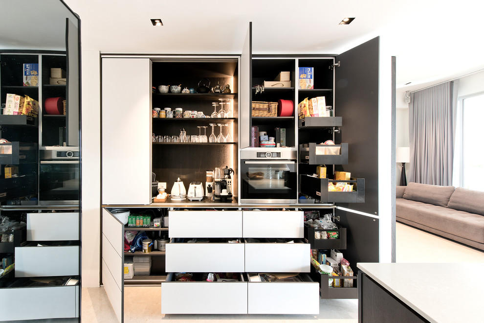 Inspiration for a contemporary kitchen pantry in Singapore with flat-panel cabinets, white cabinets and beige floor.