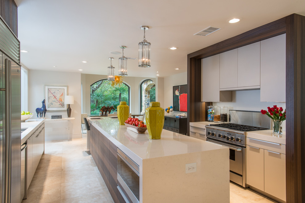 This is an example of a modern u-shaped eat-in kitchen in Houston with an undermount sink, flat-panel cabinets, white cabinets, stainless steel appliances, travertine floors, with island, quartz benchtops, white splashback and stone slab splashback.