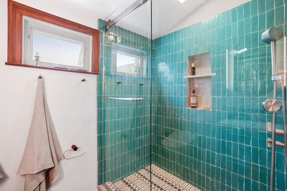 Photo of a small eclectic master bathroom in San Francisco with flat-panel cabinets, brown cabinets, an alcove shower, a bidet, green tile, terra-cotta tile, white walls, cement tiles, an integrated sink, multi-coloured floor, a sliding shower screen, white benchtops, a single vanity and a built-in vanity.