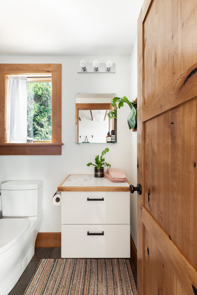 Inspiration for a small contemporary 3/4 bathroom in Portland with flat-panel cabinets, white cabinets, a two-piece toilet, white walls, concrete floors, terrazzo benchtops, grey floor and white benchtops.